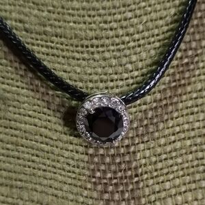 Silvertone Black faceted crystal clear crystals round pendant on black